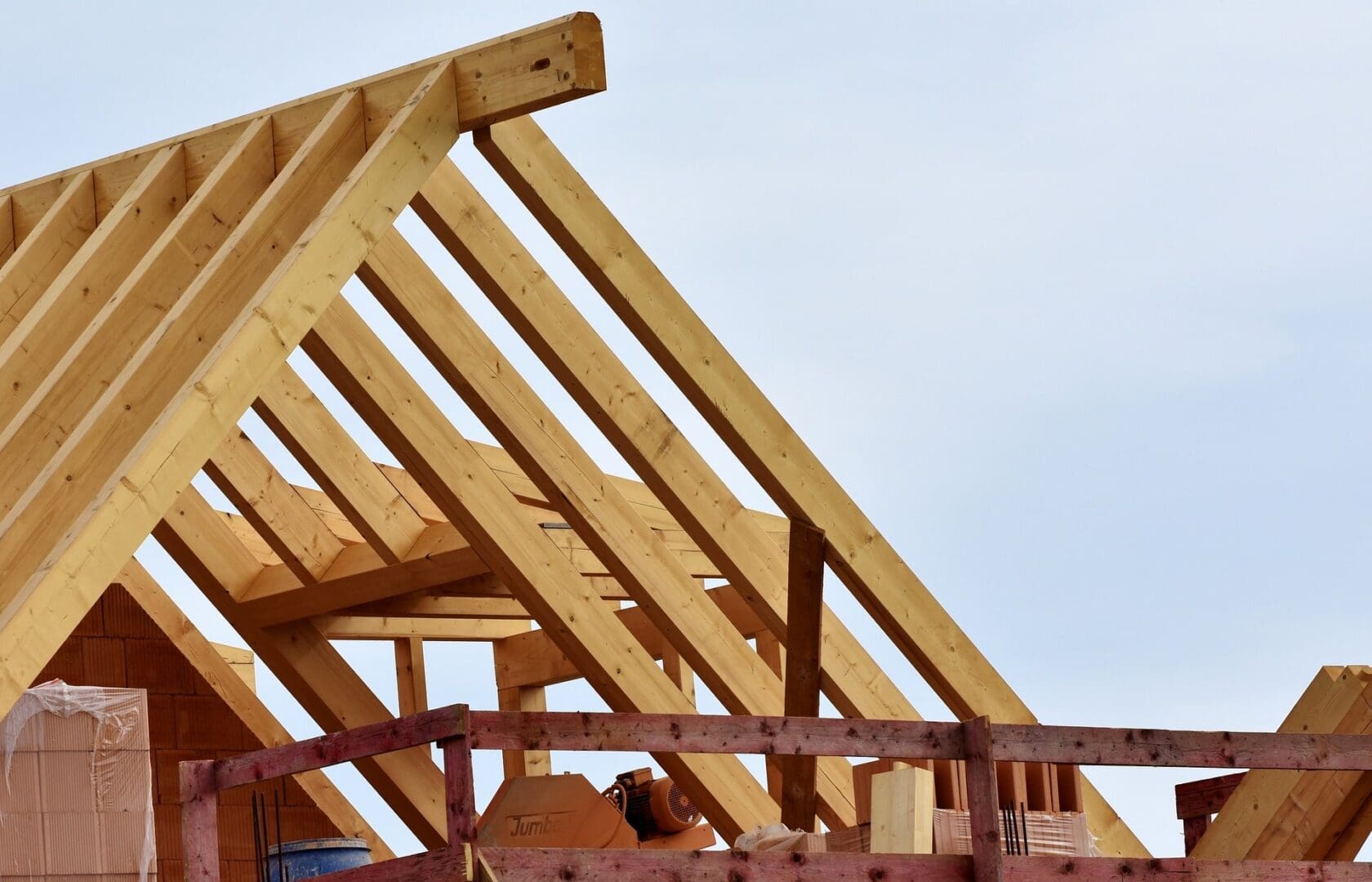 A wooden roof structure being built on top of a building.